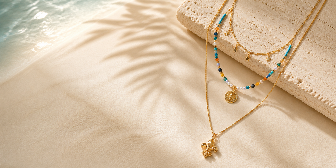 Layered gold and turquoise necklaces in warm coastal summer light