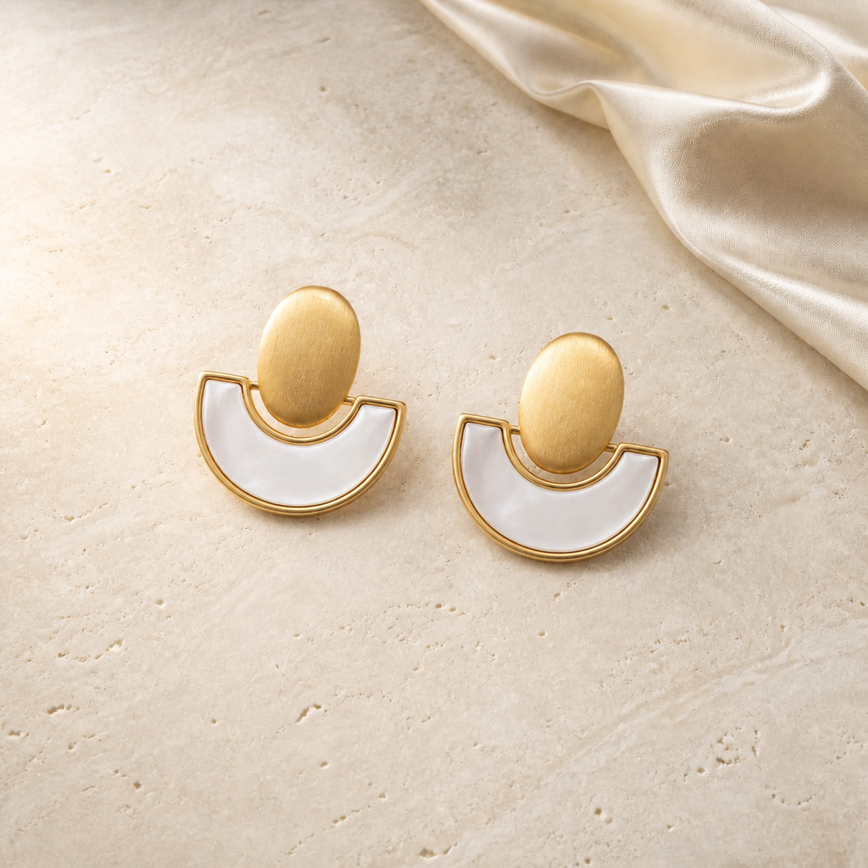 Ivory Eclipse Earrings gold and mother-of-pearl flat lay