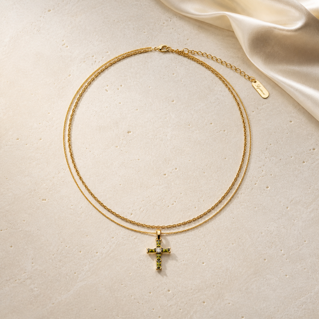 Olive green cross layered necklace on ivory travertine