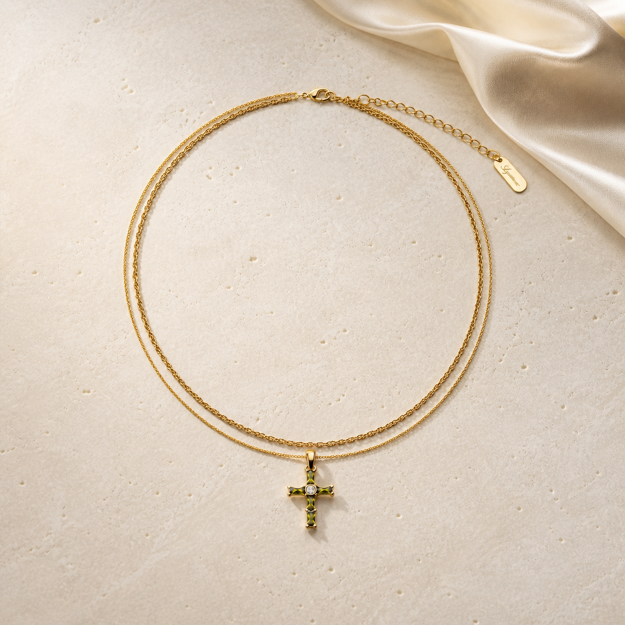 Olive green cross layered necklace on ivory travertine