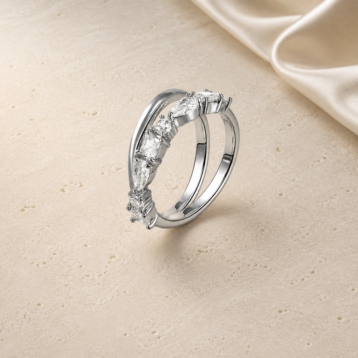 Silver double-layer marquise zircon ring on ivory travertine