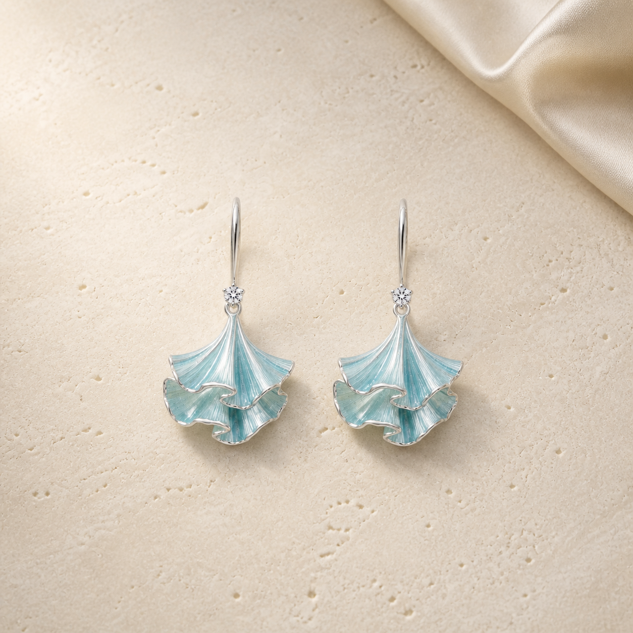 Coral Inspired Sculpted Drop Earrings on warm ivory travertine
