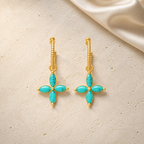 Aegean Cross Earrings on warm ivory travertine