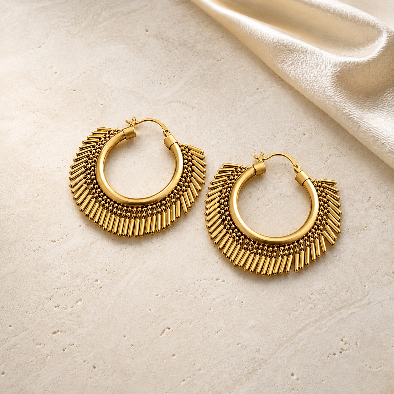 Sculpted Brass Statement Hoop Earrings on warm ivory travertine