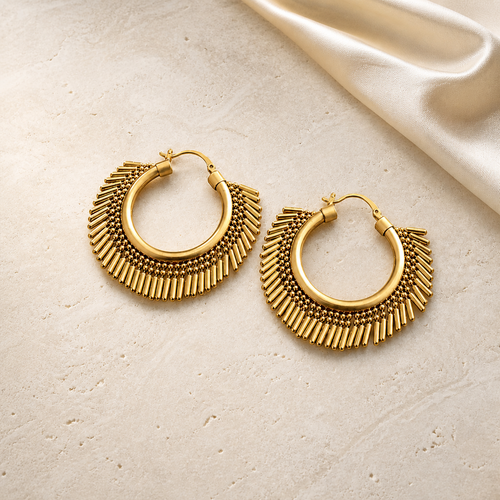 Sculpted Brass Statement Hoop Earrings on warm ivory travertine