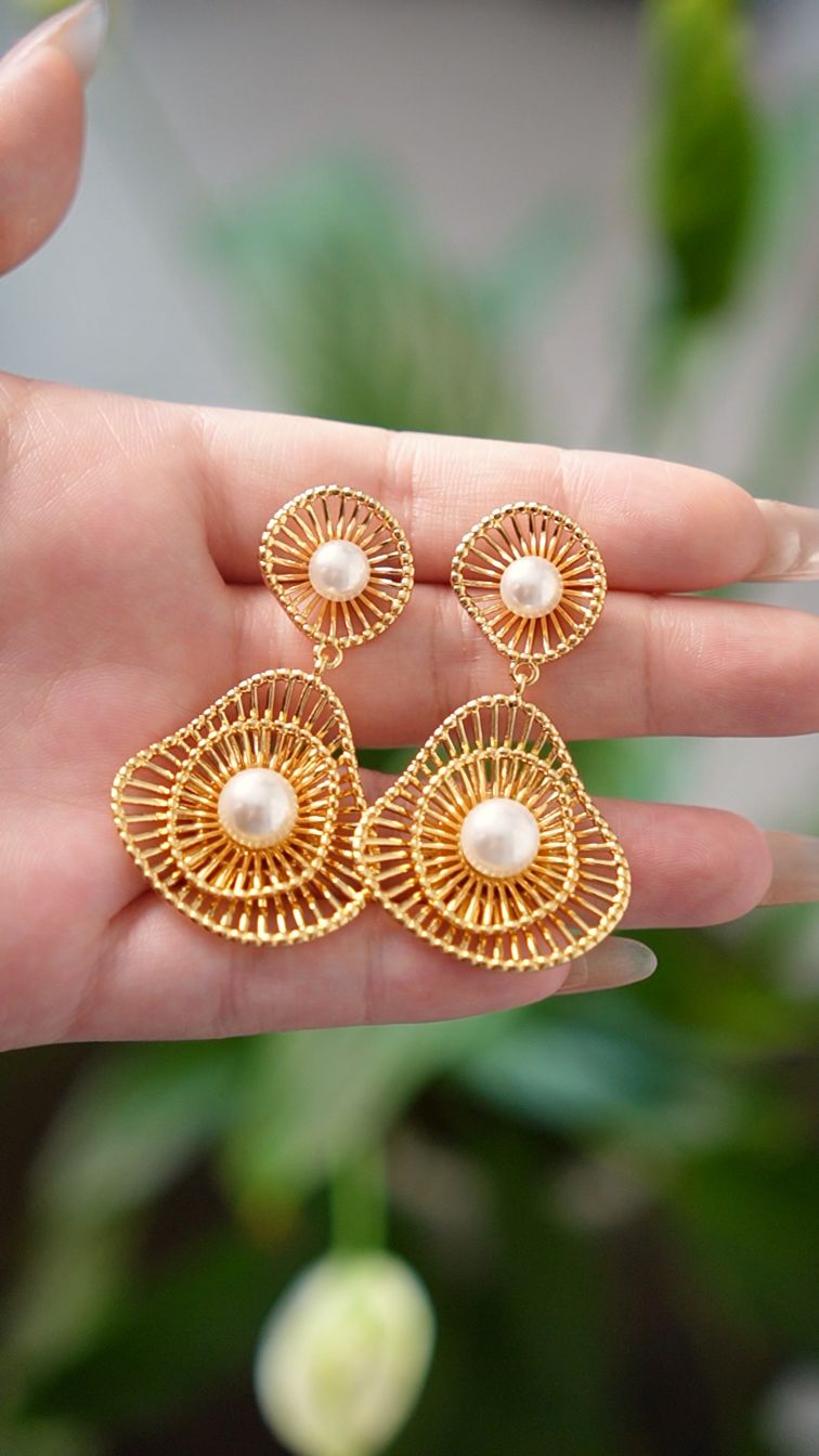 Gold statement earrings with pearls