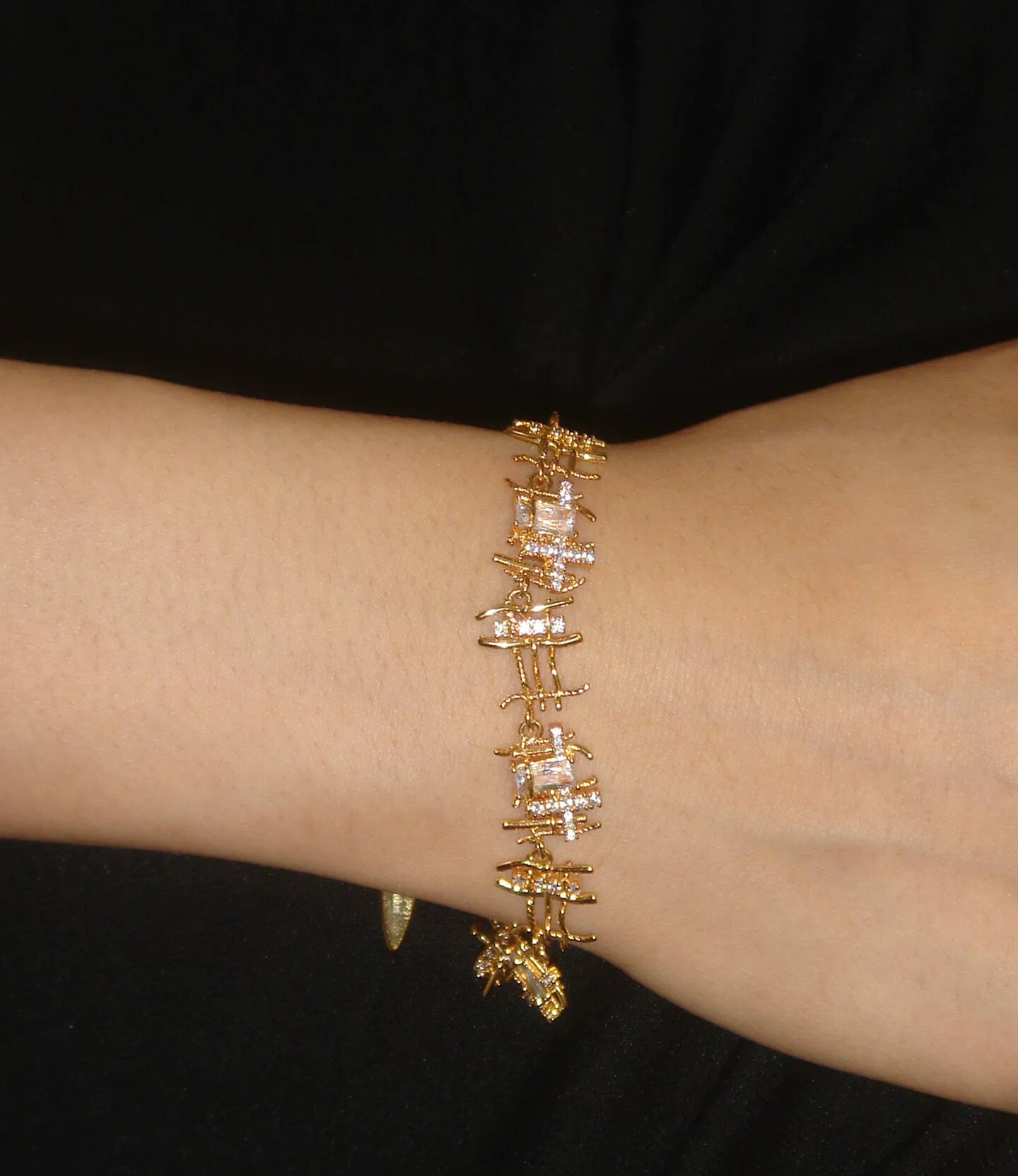 Gold woven bracelet with cubic zirconia
