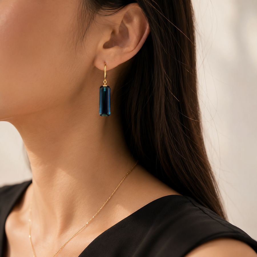 Close view of the faceted deep blue crystal on Midnight Prism Earrings