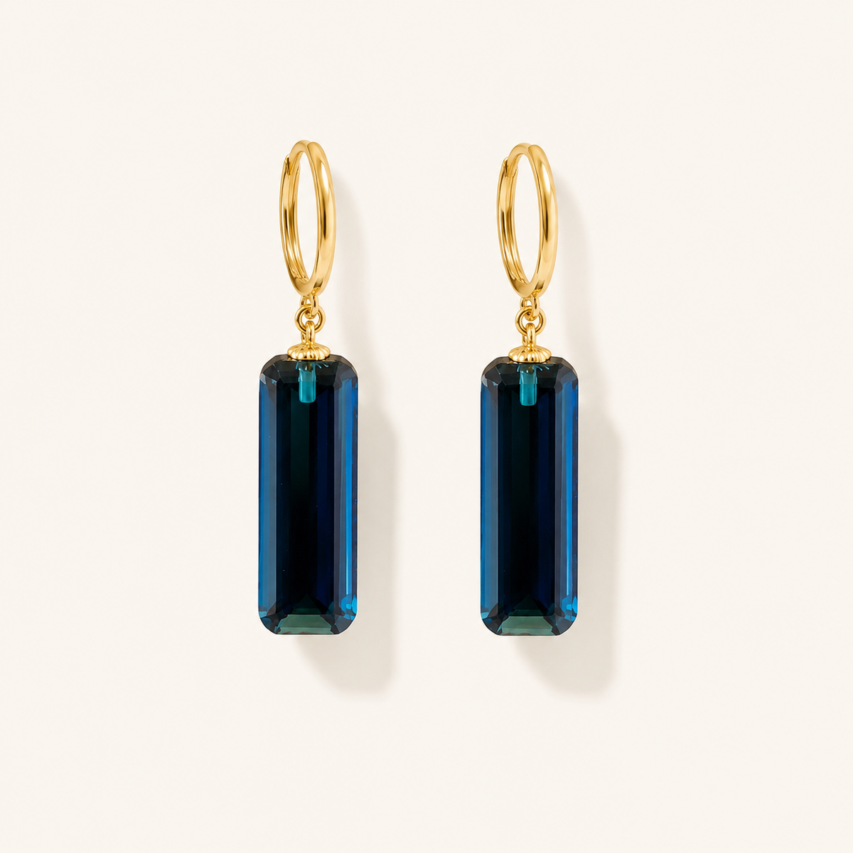 Gold-plated hoop and blue crystal detail on Midnight Prism Earrings