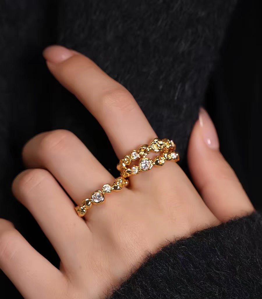 Gold ring with diamonds on a hand