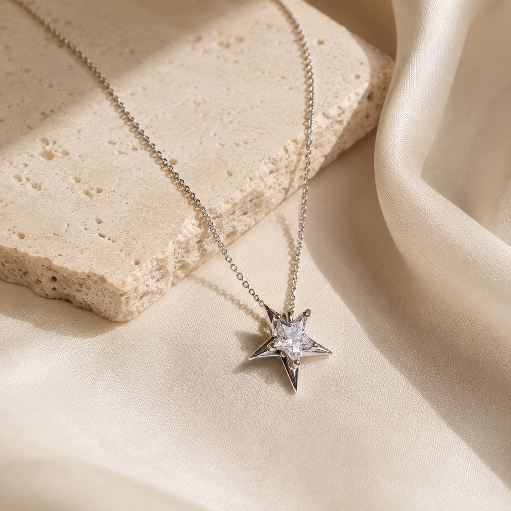 Astra Star Necklace styled on ivory satin and stone