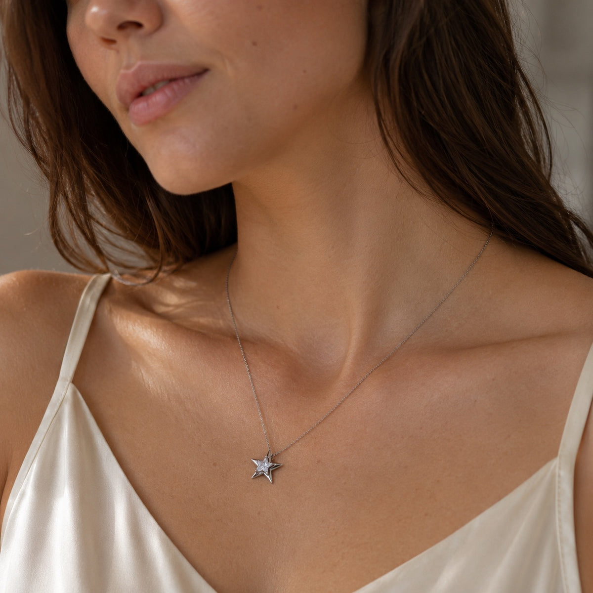 Model wearing Astra Star Necklace in silver tone