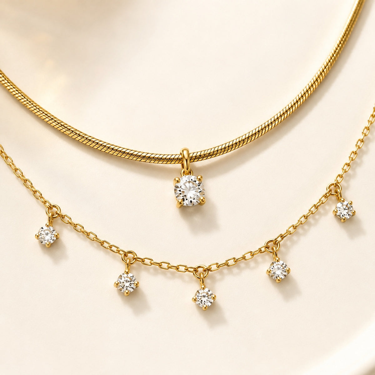 Aurelia Gold Solitaire and Five-Stone Necklace close-up showing chain and stone settings