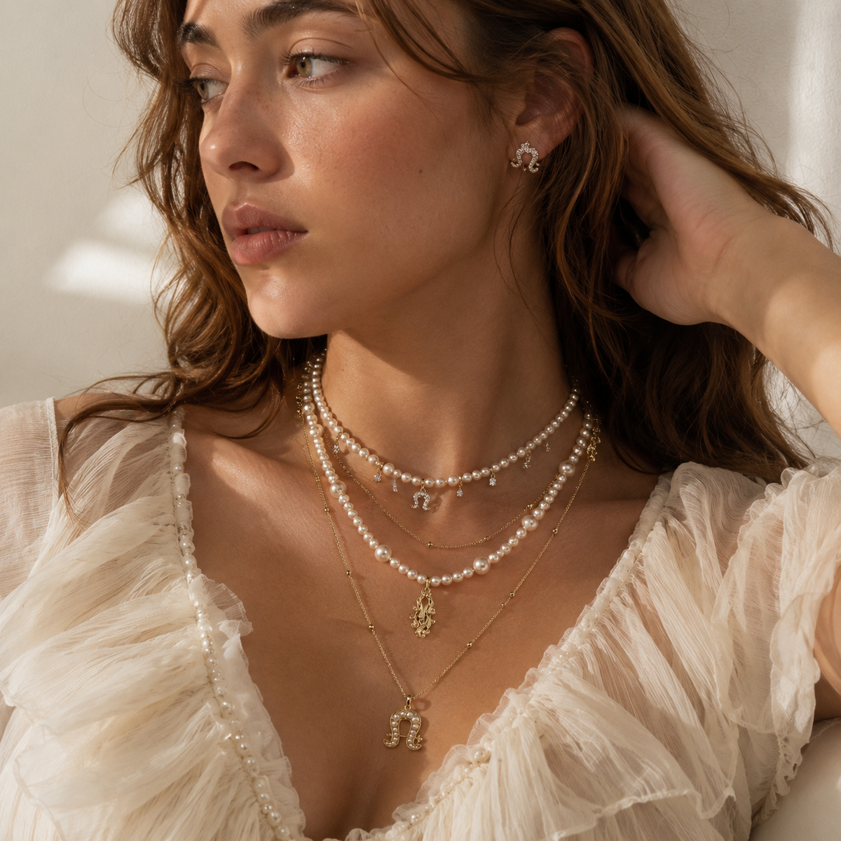 Model wearing Aurora Equestrian Pearl Layered Necklace in natural light