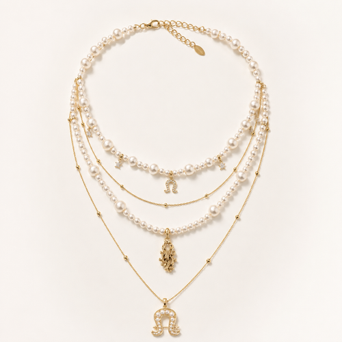 Front view of Aurora Equestrian Pearl Layered Necklace on warm ivory background