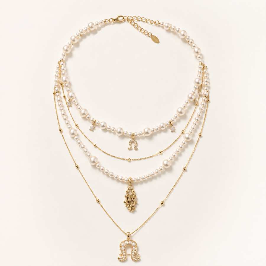 Front view of Aurora Equestrian Pearl Layered Necklace on warm ivory background