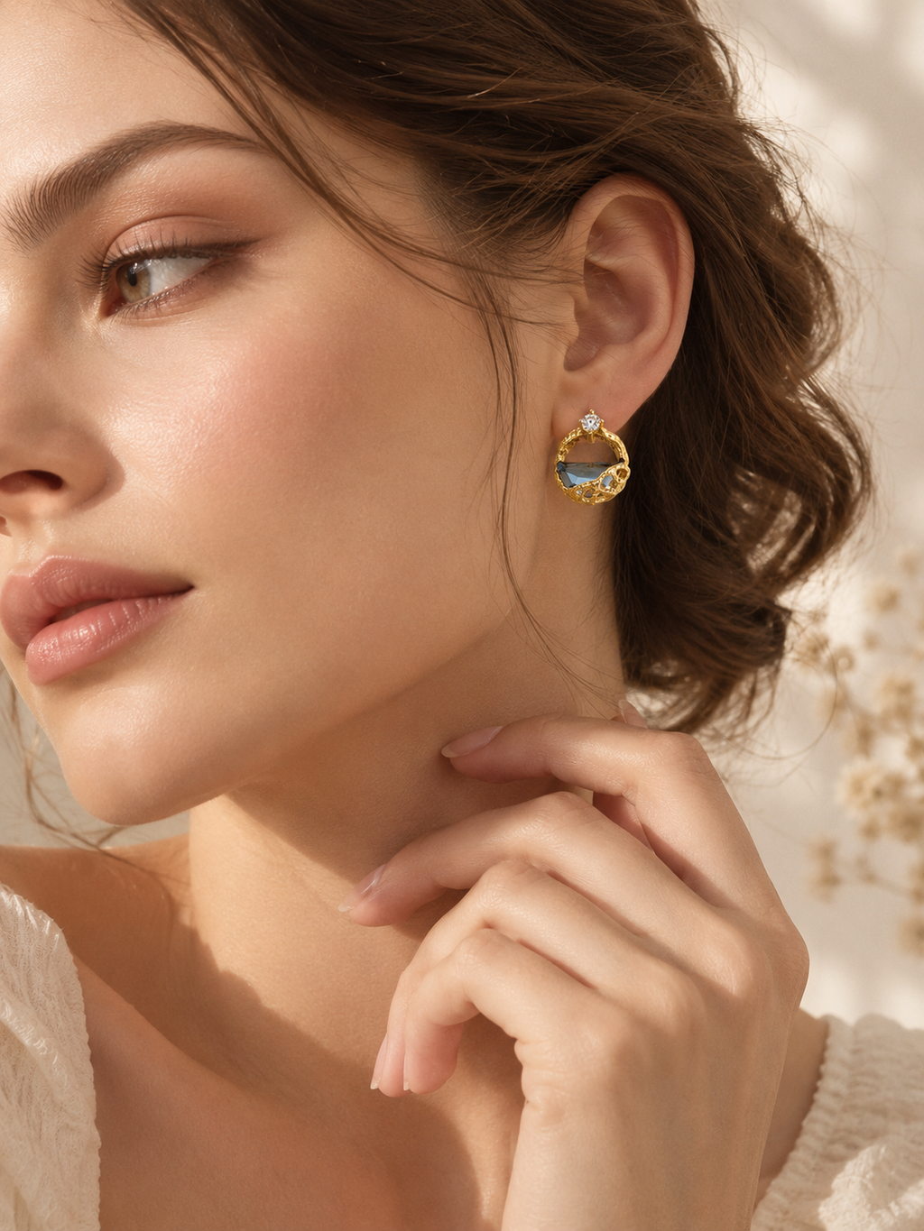 Model wearing Celeste blue crystal statement stud earrings in warm natural light