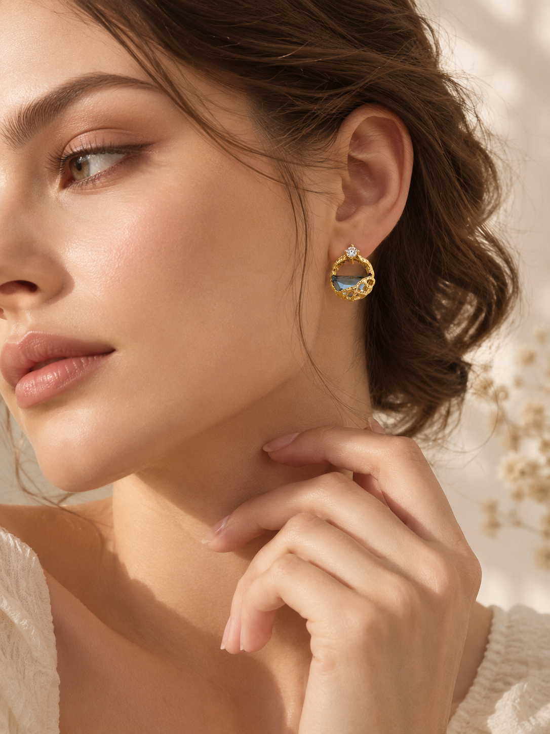 Model wearing Celeste blue crystal statement stud earrings in warm natural light