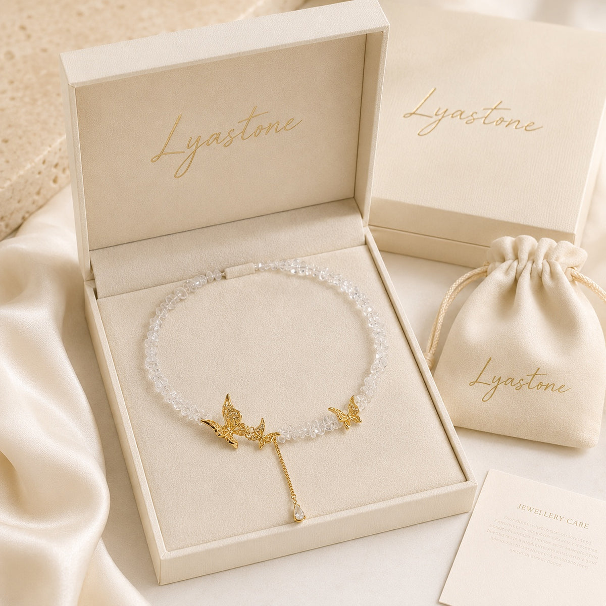 Gold tone crystal butterfly necklace presented in Lyastone gift packaging.