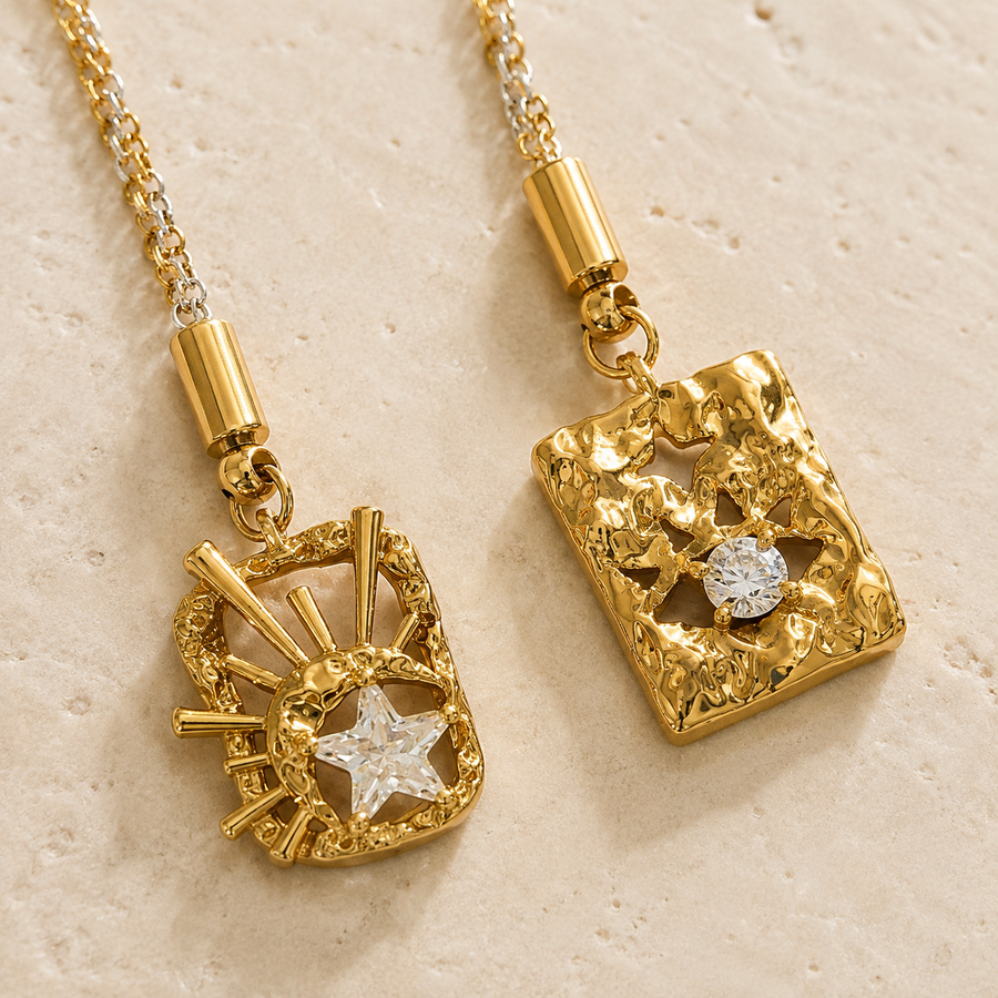 Close-up of the Celestial Duo Lariat Necklace showing its star crystal, round crystal and textured pendants.