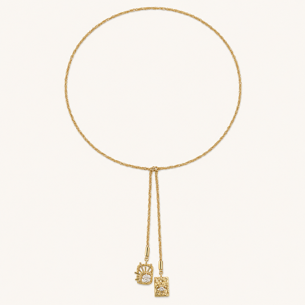 Celestial Duo Lariat Necklace on an ivory background showing its twisted chain and two pendant drops.