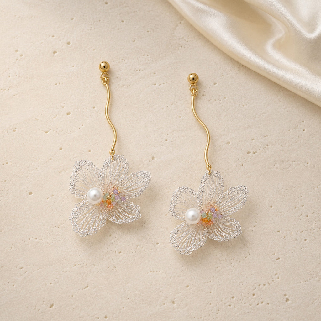 Ethereal Bloom Earrings on warm ivory travertine