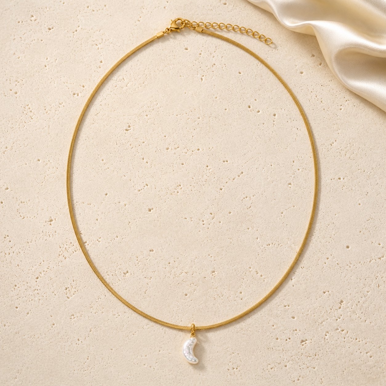 Golden Moonlight Necklace on warm ivory travertine