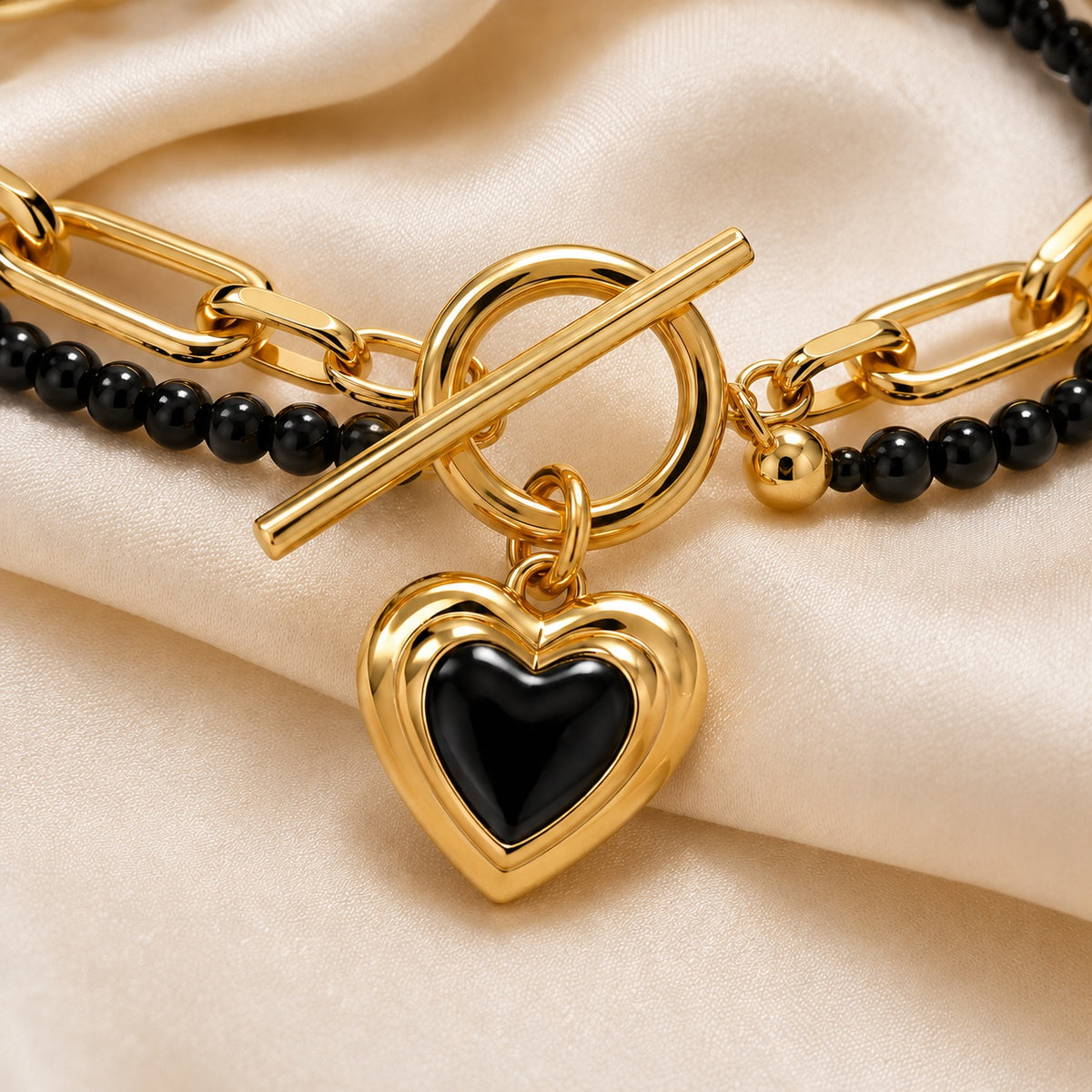 Close-up of Amoura Heart Toggle Bracelet toggle clasp and black heart charm