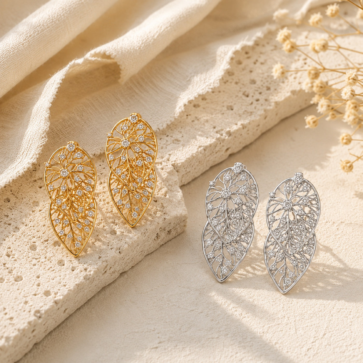 Hollow Zircon Leaf Earrings on warm ivory travertine