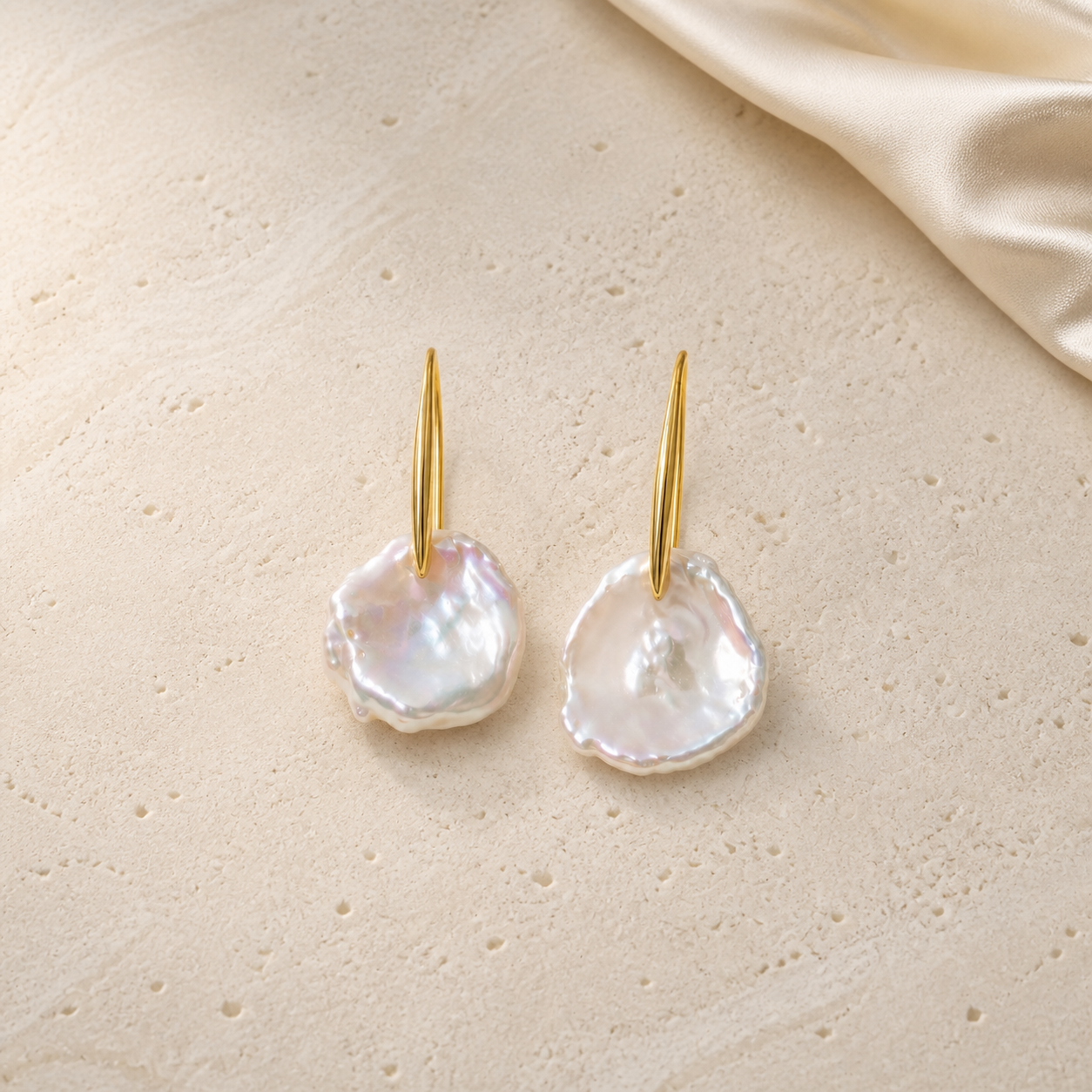 Irregular-Shaped Pearl Earrings on warm ivory travertine