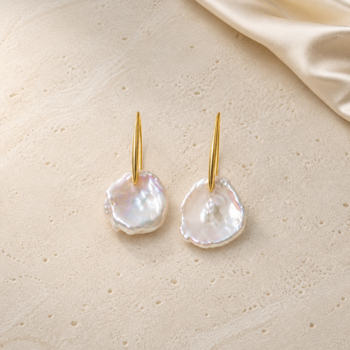 Irregular-Shaped Pearl Earrings on warm ivory travertine