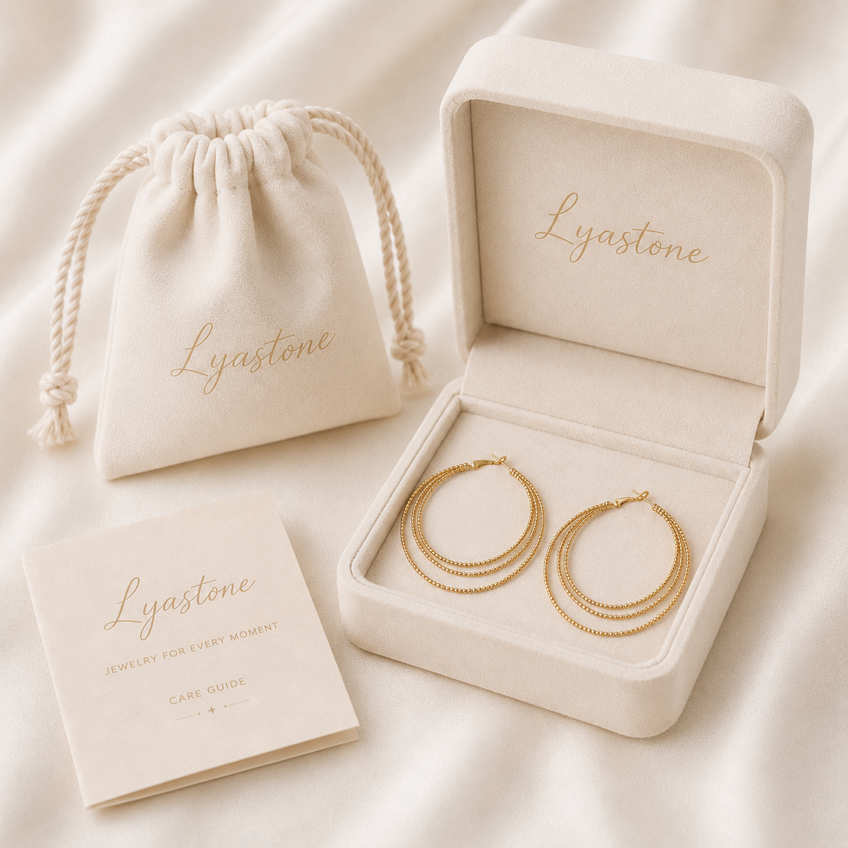 Aurelia triple hoop earrings presented in Lyastone warm ivory gift packaging