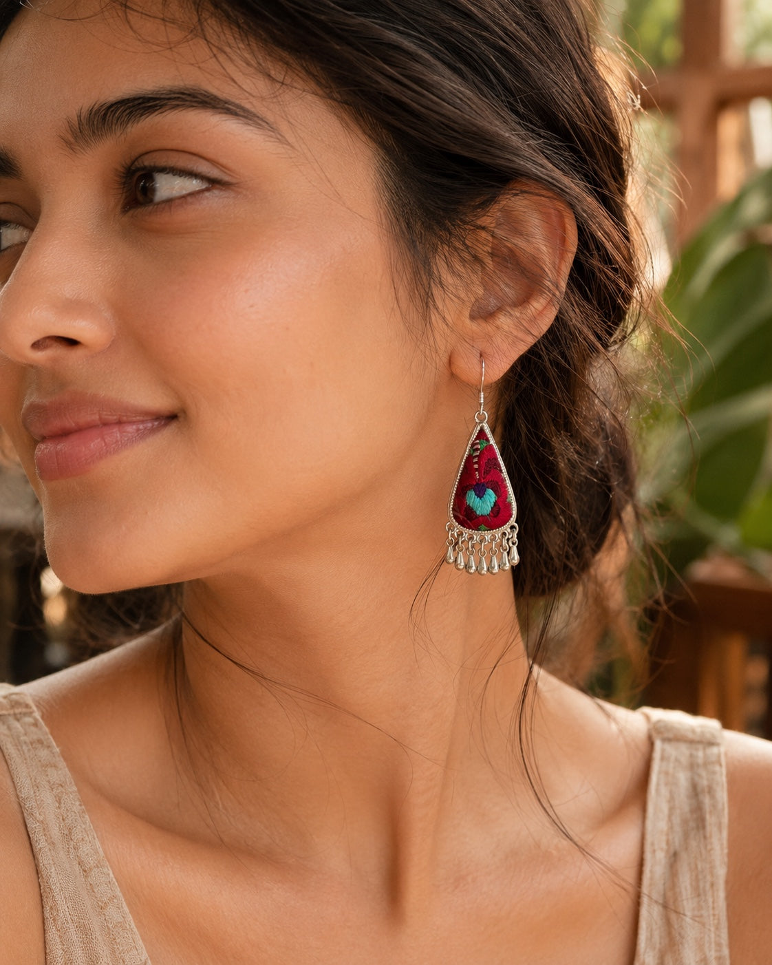 Model wearing Crimson Bloom hand embroidered silver drop earrings