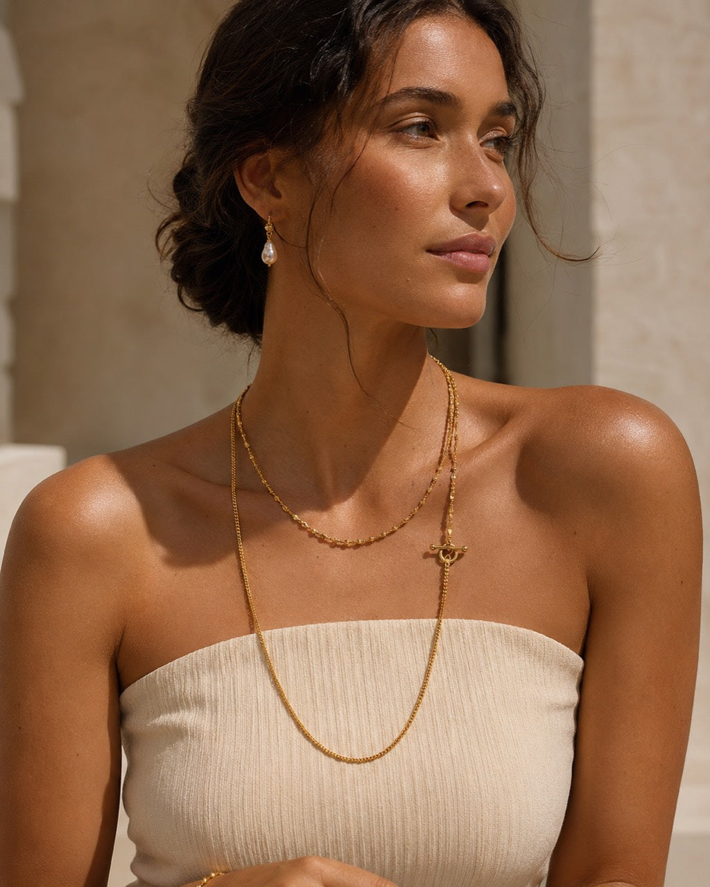 Imperfect Bloom OT Long Necklace styled on model with layered gold chains