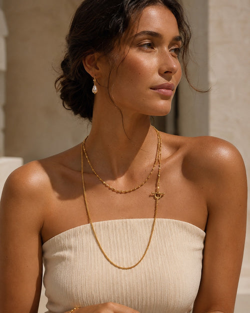 Imperfect Bloom OT Long Necklace styled on model with layered gold chains