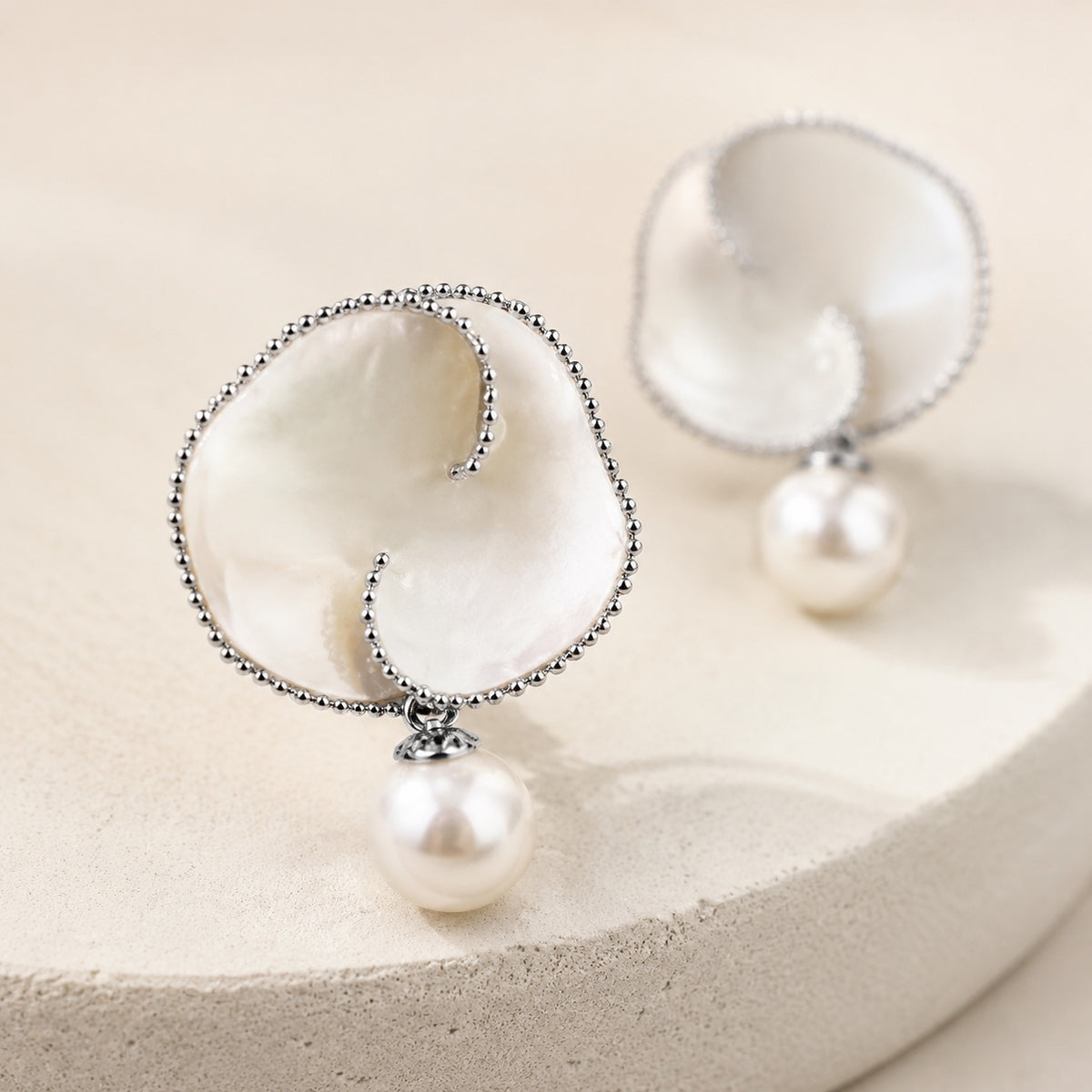 Close-up of Nacre Bloom natural mother-of-pearl petals with rhodium-plated beaded edge
