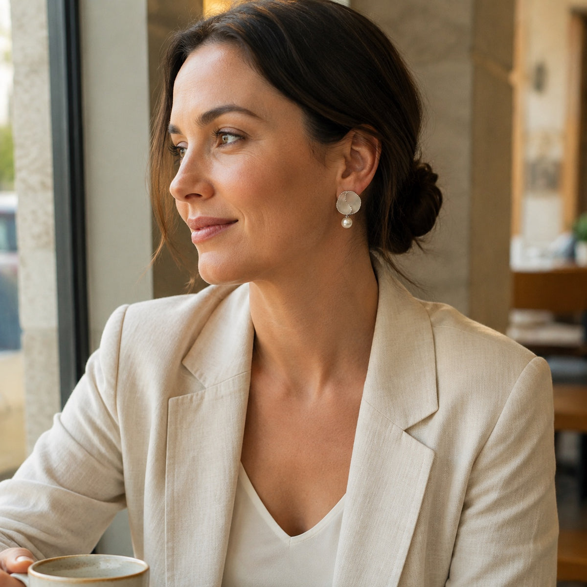 Model wearing Nacre Bloom mother-of-pearl pearl drop earrings