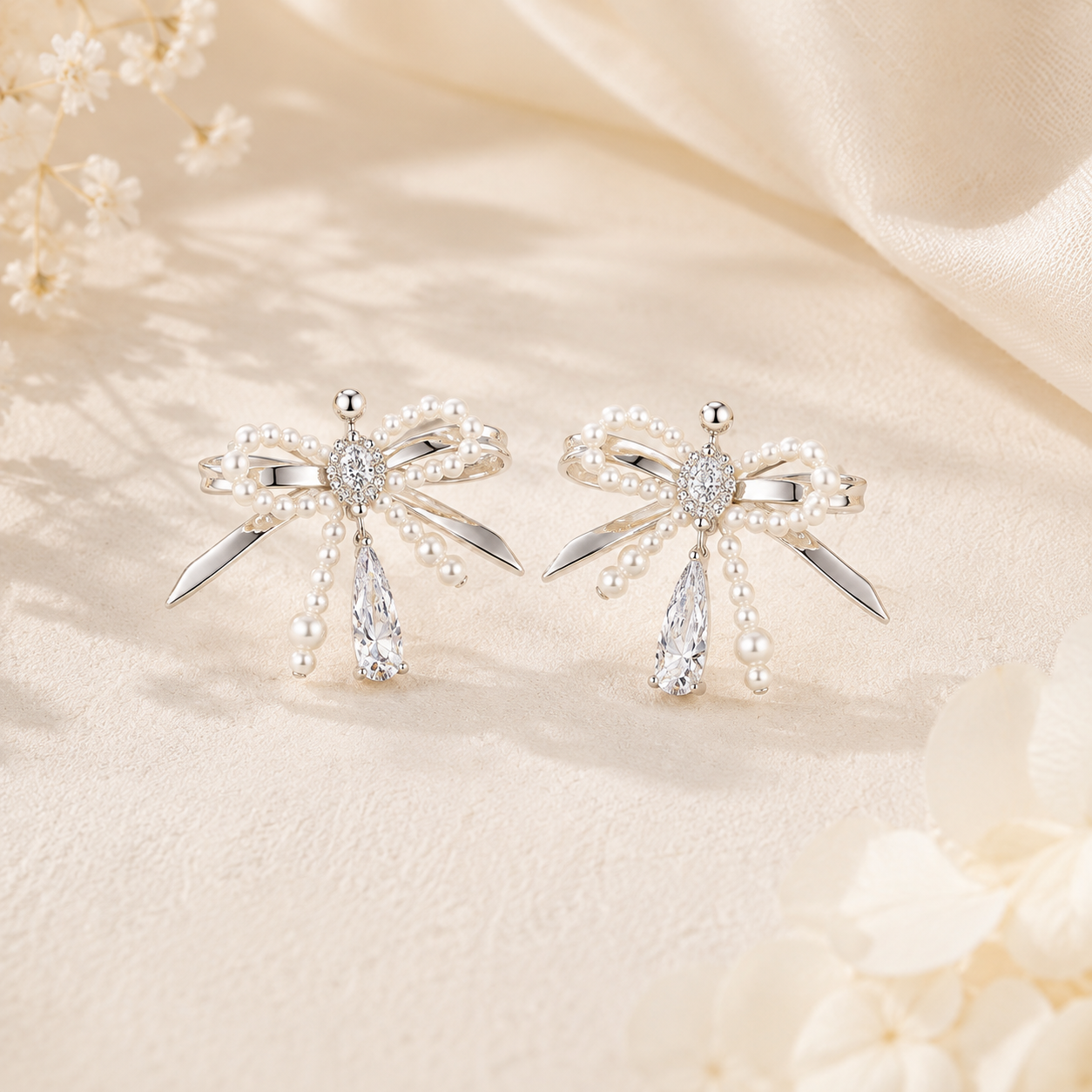 Lyastone silver pearl bow crystal drop earrings hero image