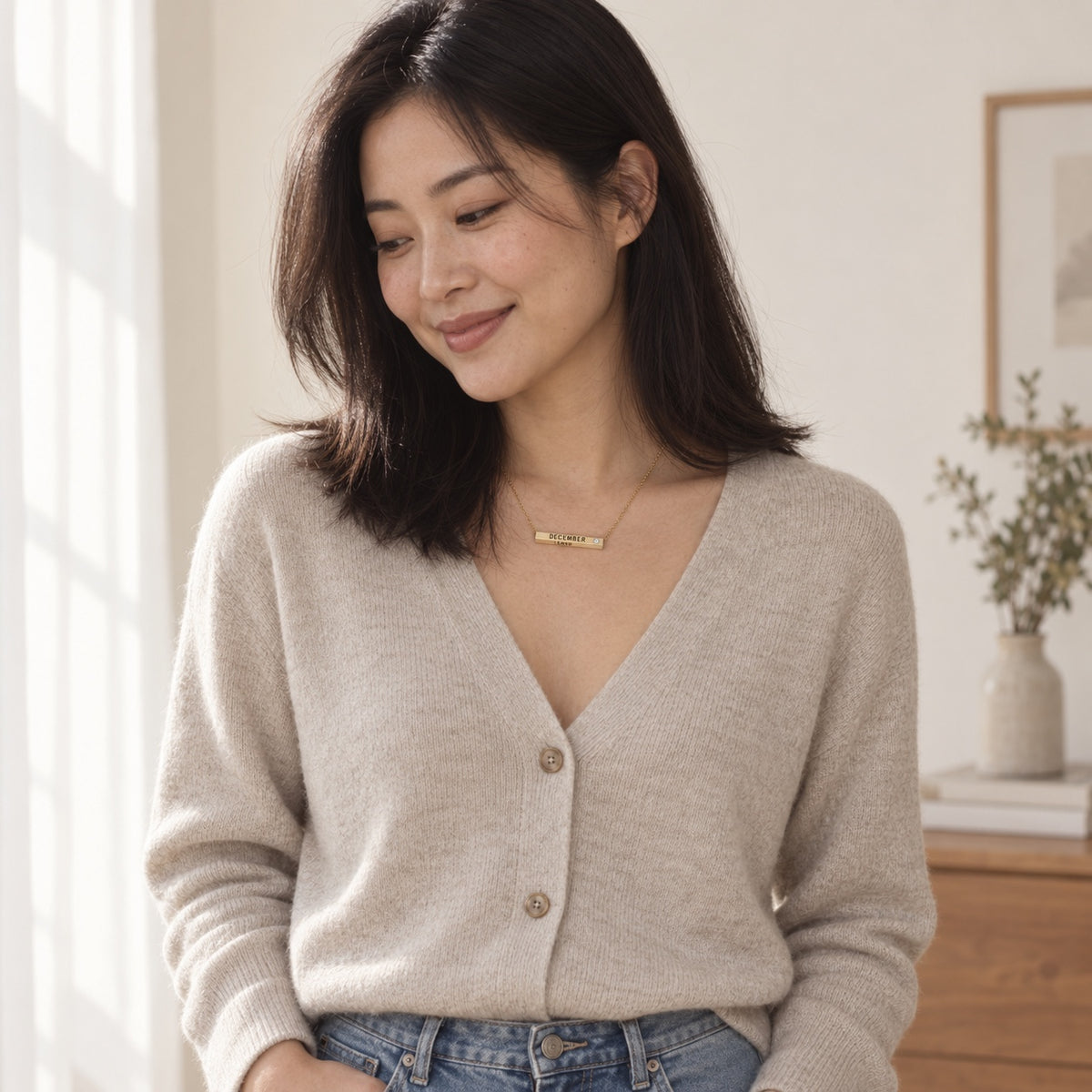 December Month of Love necklace styled with a neutral cardigan