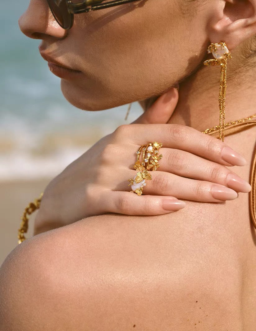 Sunlit Tide butterfly pearl ring styled with matching earrings in gold