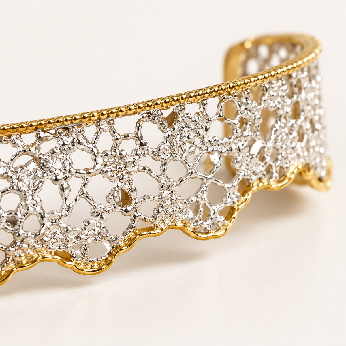 Close-up of silver lace-inspired openwork, CZ accents and gold-plated trim