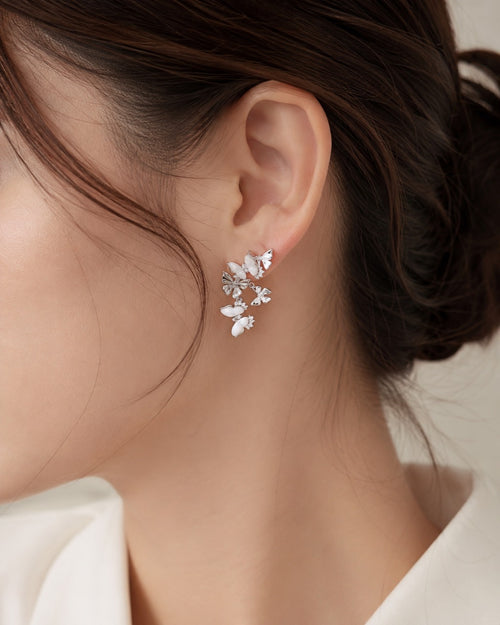 White mother of pearl butterfly drop earrings worn on ear by Lyastone