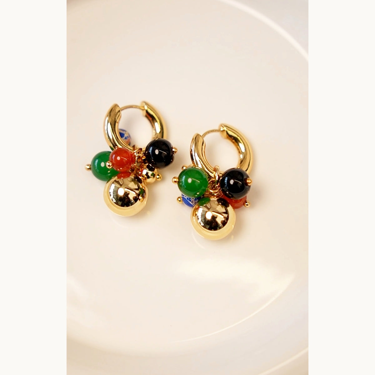 Close-up detail of Lyastone Mosaic Charm Huggie Earrings