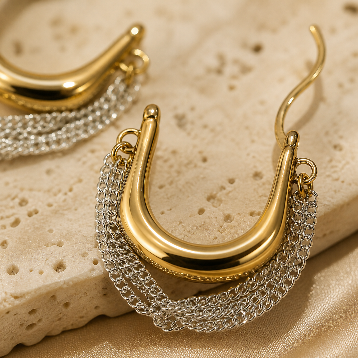 Close-up of Solara Cascade polished gold-tone hoops and fine silver-tone chains
