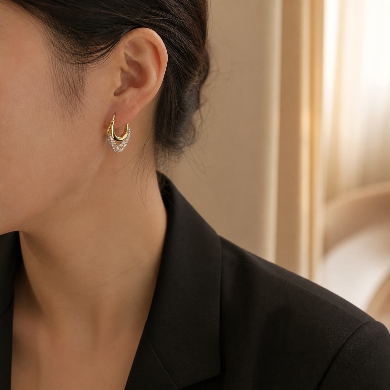 Model wearing Solara Cascade gold and silver-tone hoop earrings