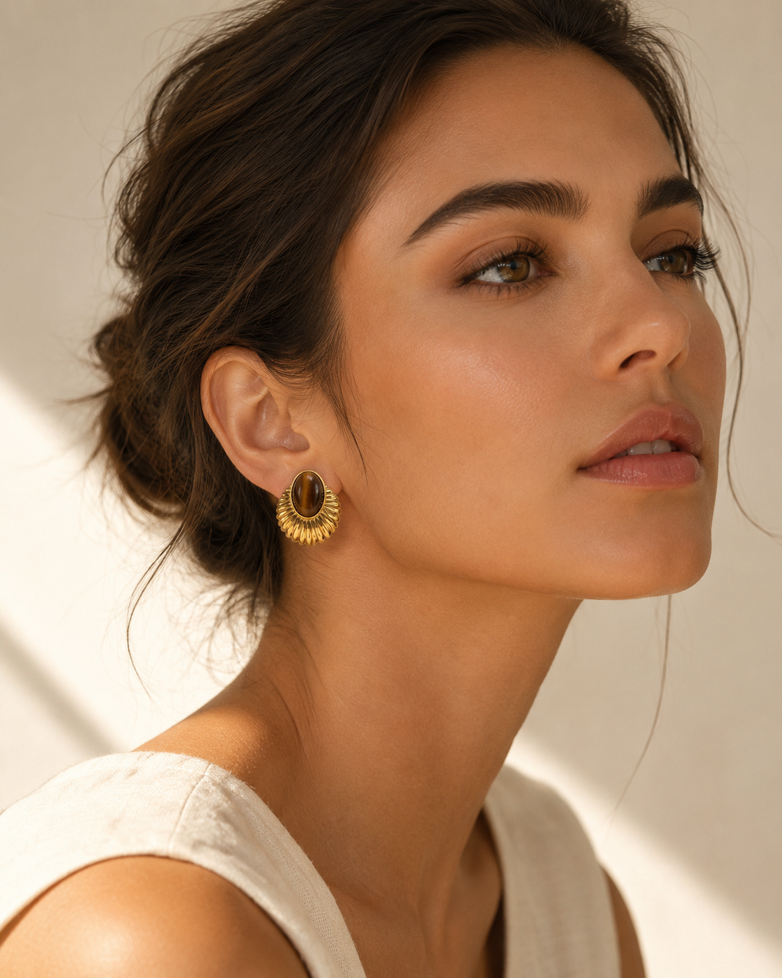 Model wearing Solis tiger eye gold stud earrings