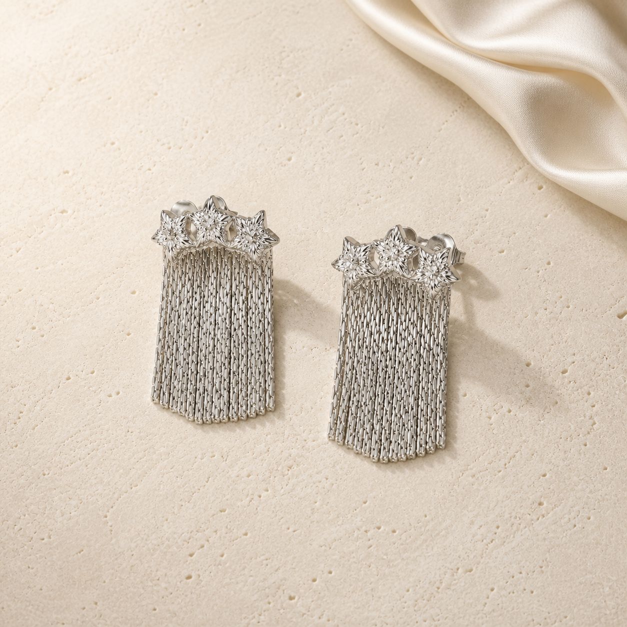 Star Whisper Tassel Earrings on warm ivory travertine