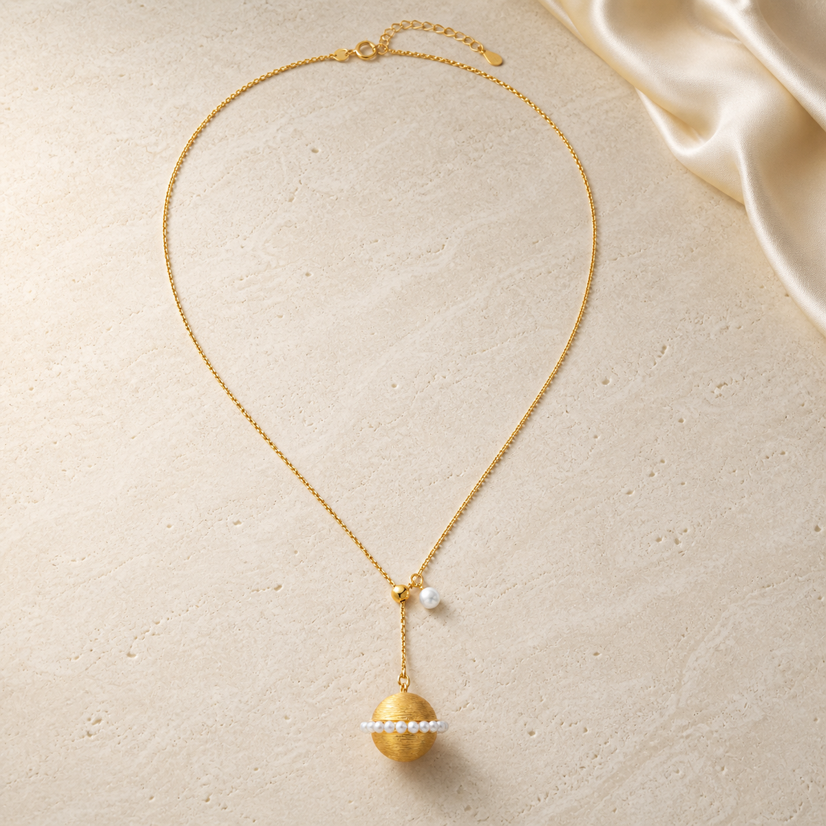 Starlight Pearl Necklace on warm ivory travertine